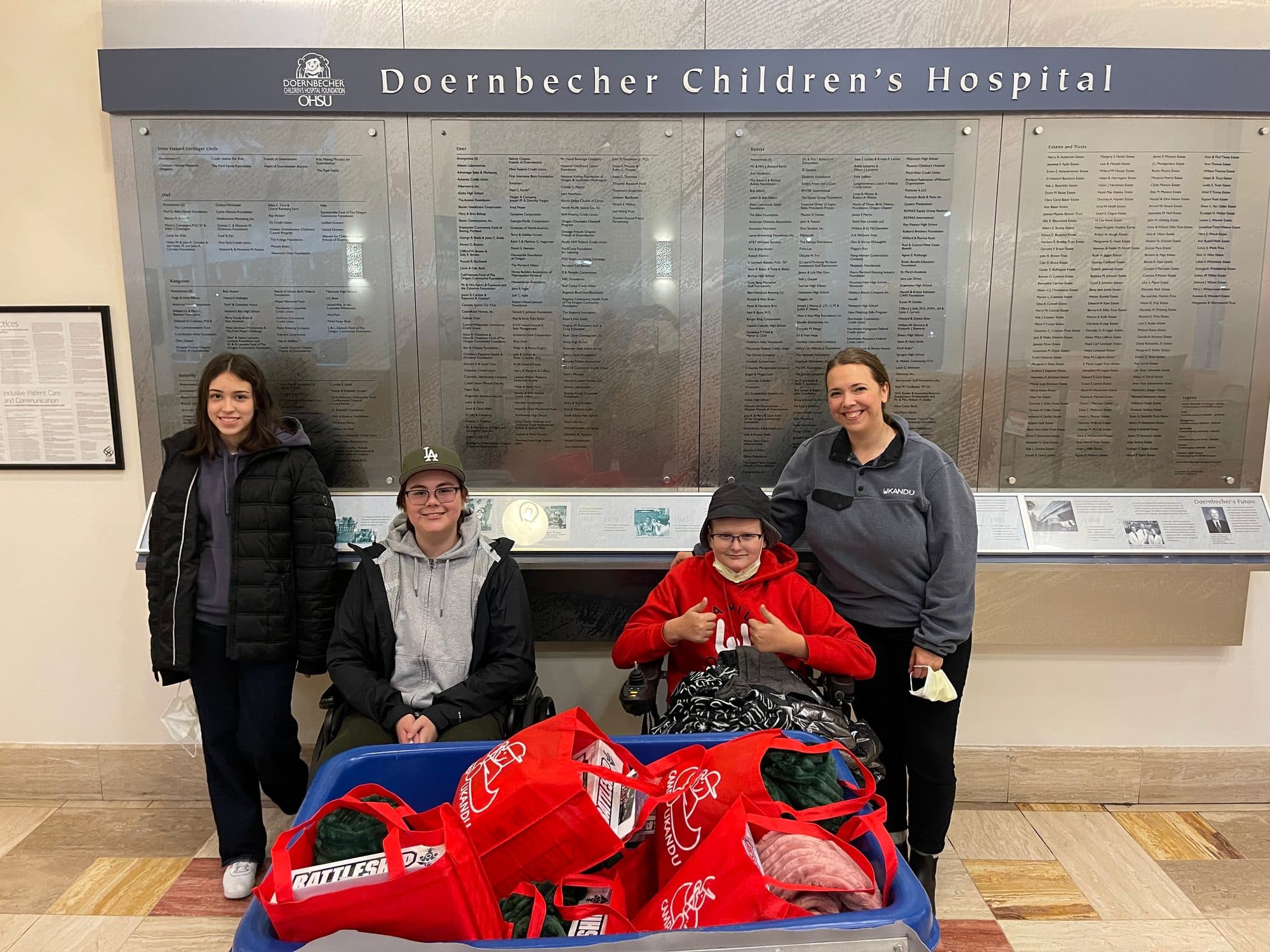 A group holding donation bags outside Doernbecher